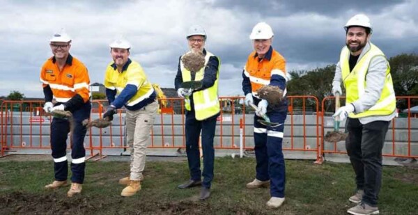 Executives from Akaysha and their construction partners turn the first sod with shovels at the Brendale Battery site