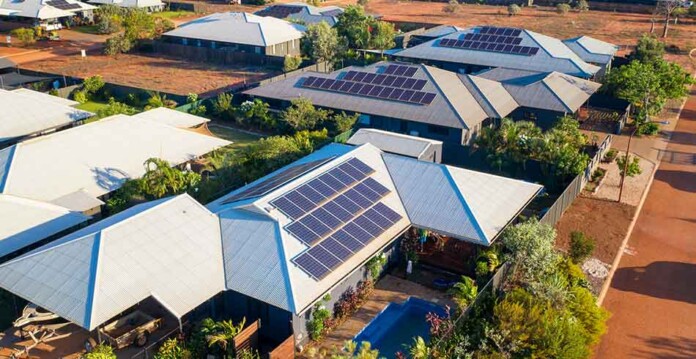 Aerial image of homes in Broome with rooftop solar, and red dirt roads